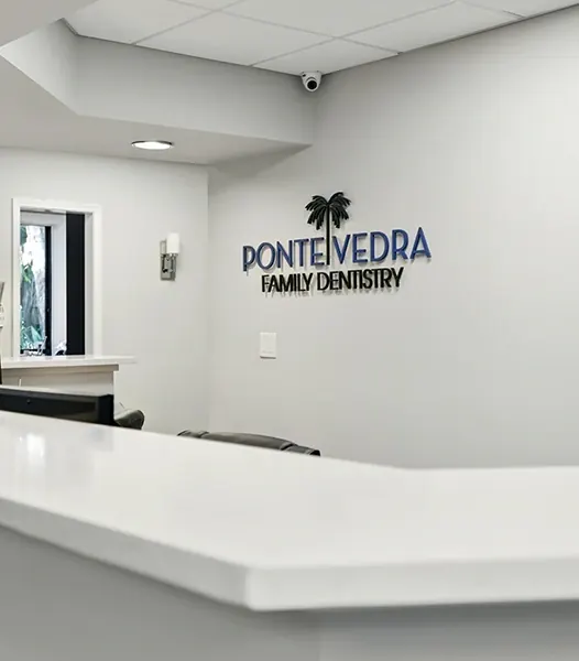 The front counter, with the practice logo on the wall behind it.